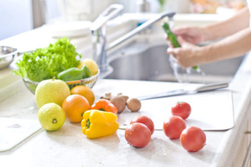 Vegetables and ingredients housewife cooking in the kitchen