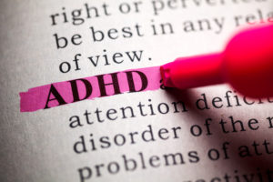 Dictionary, pink highlighted definition of the word ADHD.