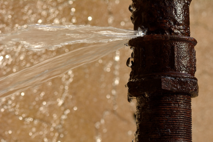 An old pipe breaks spraying water