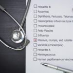 Clipboard with vaccine list, MMR checked off