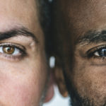 Two different ethnic men's eyes closeup