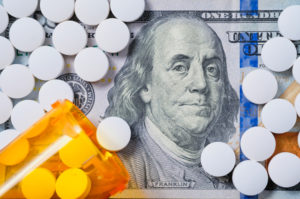 White prescription pills on US $100 currency