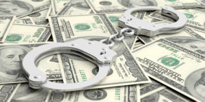 Handcuffs on dollar banknotes