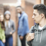 Teenage Boy Walks Home Isolated from friends