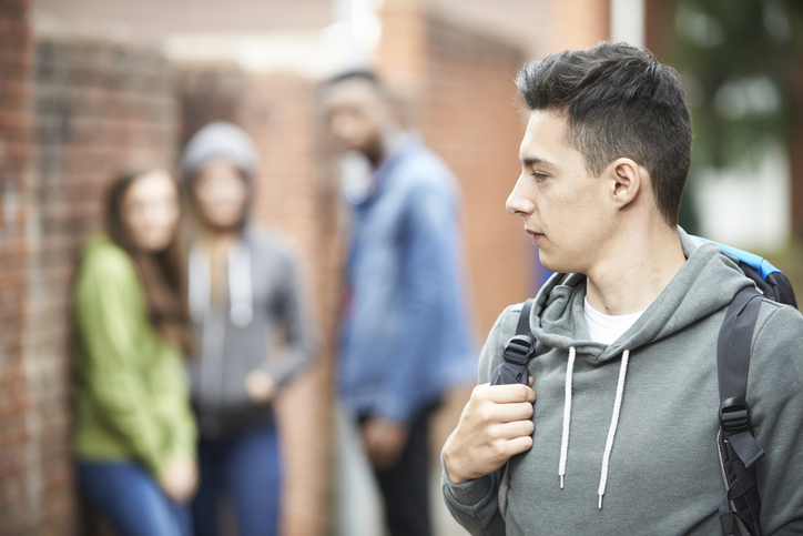 Teenage Boy Walks Home Isolated from friends