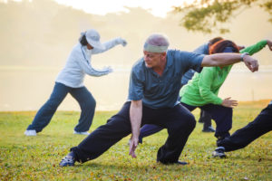 people practice Tai Chi Chuan in a park