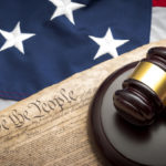 American flag, US constitution and a judge's gavel