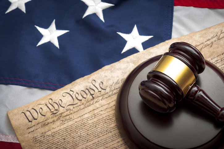 American flag, US constitution and a judge's gavel