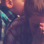 Crying stressed-out mother with child at home