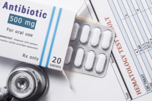 Antibiotic pills and stethoscope