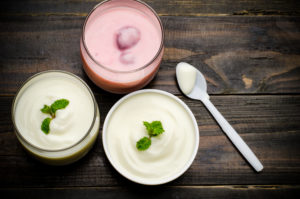 Homemade yogurt in the glass on wooden table
