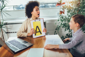 Shot of a speech therapist during a session with a little boy