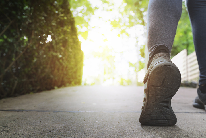 Close up woman running shoes, jogging on the road in a park