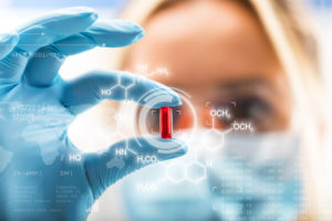 Young female scientist holding a red transparent pill with futuristic scientific air interface with chemical formulas and research data in the foreground