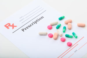 Pills on a blank prescription on white background