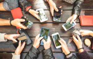 People group having addicted fun together using smartphones - Detail of hands sharing content on social network with mobile smart phones.